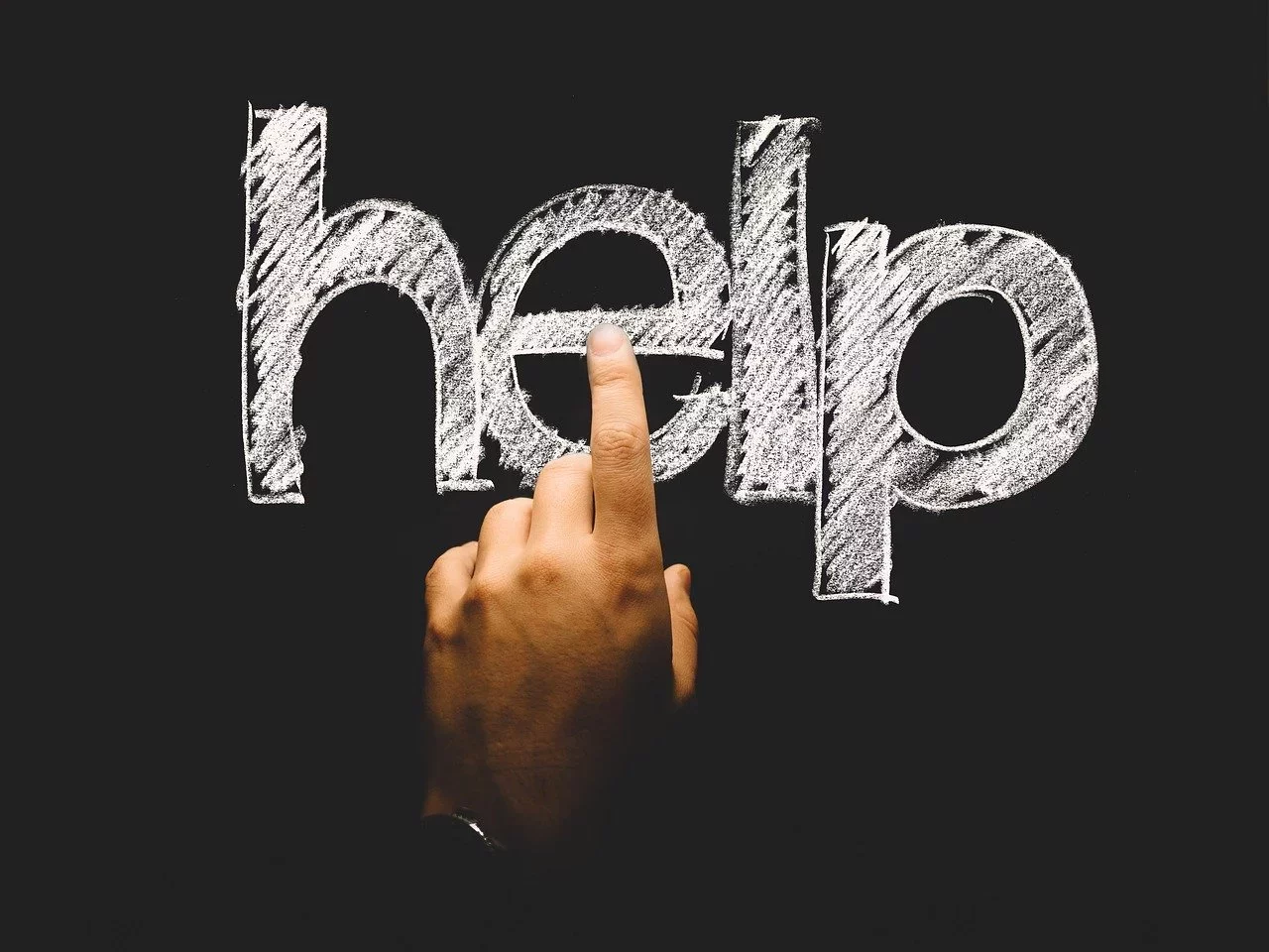 help, finger, touch-2478193 hand and finger pointing to the word HELP on a chalk board.